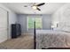 Charming bedroom featuring blue walls, carpet floors, and a decorative ceiling fan at 266 Blue Point Pkwy, Fayetteville, GA 30215