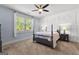 A bedroom suite featuring a four-poster bed, light blue walls, and a window at 266 Blue Point Pkwy, Fayetteville, GA 30215