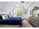 A bedroom suite featuring a decorative ceiling, a large bed with a blue coverlet, and a grey dresser at 266 Blue Point Pkwy, Fayetteville, GA 30215
