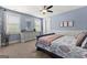 Bright bedroom with a large window, blue walls, carpet floors and a comfortable bed at 266 Blue Point Pkwy, Fayetteville, GA 30215