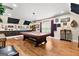 Spacious billiard room featuring hardwood floors, decorative lighting, and a pool table at 266 Blue Point Pkwy, Fayetteville, GA 30215