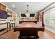 Billiard room with hardwood floors, decorative lights, and a covered pool table at 266 Blue Point Pkwy, Fayetteville, GA 30215
