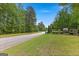 Well-maintained entrance to a residential community with manicured lawns, trees, and signage at 266 Blue Point Pkwy, Fayetteville, GA 30215