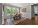 Bright dining room featuring a chandelier, large windows overlooking the backyard, and elegant wainscoting details at 266 Blue Point Pkwy, Fayetteville, GA 30215