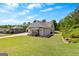 Charming home with manicured lawn, stone accents, and lush landscaping on a sunny day at 266 Blue Point Pkwy, Fayetteville, GA 30215
