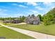 View of a well-manicured lawn and beautifully designed home nestled in a serene neighborhood at 266 Blue Point Pkwy, Fayetteville, GA 30215
