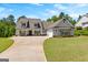 Charming home with a lush green lawn, a welcoming front porch and an extended driveway at 266 Blue Point Pkwy, Fayetteville, GA 30215