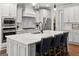 Modern kitchen with white cabinets, stainless appliances and large center island at 266 Blue Point Pkwy, Fayetteville, GA 30215