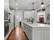 Open kitchen with stainless steel appliances, a large island, and white cabinets at 266 Blue Point Pkwy, Fayetteville, GA 30215