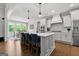 Bright kitchen features white cabinetry, a center island with seating, and a view to the breakfast nook at 266 Blue Point Pkwy, Fayetteville, GA 30215