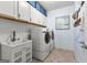 Well-organized laundry room features a sink, counter space, storage cabinets and modern washer and dryer units at 266 Blue Point Pkwy, Fayetteville, GA 30215
