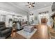 Open concept living room and kitchen with wood floors and a large sectional couch at 266 Blue Point Pkwy, Fayetteville, GA 30215