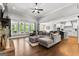 Open living room with stone fireplace, hardwood floors, and access to the kitchen at 266 Blue Point Pkwy, Fayetteville, GA 30215