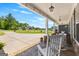 Inviting front porch with rocking chairs and a view of a landscaped yard at 266 Blue Point Pkwy, Fayetteville, GA 30215