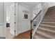 Staircase featuring carpeted steps with wood handrail and white trim at 266 Blue Point Pkwy, Fayetteville, GA 30215