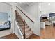 Carpeted staircase leading to the second floor, with a view of living room and bedroom at 266 Blue Point Pkwy, Fayetteville, GA 30215
