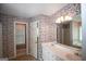 Bathroom with double sink vanity, floral wallpaper, and ample lighting fixtures at 250 Clearview Cir, Mcdonough, GA 30253