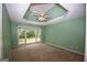 Spacious bedroom with neutral carpet, a ceiling fan, and a large window overlooking the backyard at 250 Clearview Cir, Mcdonough, GA 30253