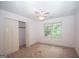 Bedroom featuring a ceiling fan, window, and closet with double doors at 250 Clearview Cir, Mcdonough, GA 30253