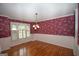 Dining room featuring wood floors, large windows with shutters, and floral wallpaper with white trim at 250 Clearview Cir, Mcdonough, GA 30253