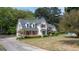 A charming two-story home featuring dormer windows, red shutters, and a spacious front yard at 250 Clearview Cir, Mcdonough, GA 30253