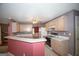 Open kitchen design with breakfast bar, tile flooring, light wood cabinets and updated appliances at 250 Clearview Cir, Mcdonough, GA 30253