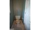 Powder room featuring tile floors, a standard toilet, and decorative green striped wall coverings at 250 Clearview Cir, Mcdonough, GA 30253