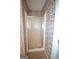 Enclosed shower stall with floral wallpaper at 250 Clearview Cir, Mcdonough, GA 30253