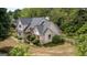 Two-story home showcasing meticulously maintained landscaping, shingle siding, and lush greenery, adding to its curb appeal at 250 Clearview Cir, Mcdonough, GA 30253