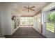 Sunroom with multiple windows and a ceiling fan, providing a bright and airy space at 250 Clearview Cir, Mcdonough, GA 30253