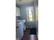 Laundry room with washer, dryer, cabinets, window, and grey trim at 6070 Ridge Way, Douglasville, GA 30135