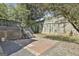 An outdoor patio area with brick pavers and a lush, green backdrop at 1449 Wadley Ave, East Point, GA 30344