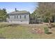 Back of home and yard with wooden deck with lattice work at 1449 Wadley Ave, East Point, GA 30344