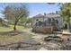 Landscaped backyard with deck, fire pit, brick patio, and spacious lawn, perfect for outdoor living and entertaining at 1449 Wadley Ave, East Point, GA 30344