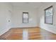 Bedroom featuring hardwood floors, two windows, and a closet at 1449 Wadley Ave, East Point, GA 30344