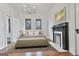 Bright bedroom features a fireplace, and a stylish chandelier at 1449 Wadley Ave, East Point, GA 30344