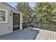 The home features a back deck area with black door, black railing and gray painted flooring at 1449 Wadley Ave, East Point, GA 30344