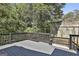A gray deck sits above a tree-lined concrete retaining wall at 1449 Wadley Ave, East Point, GA 30344