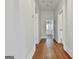 Hallway with hardwood floors leads to laundry area at 1449 Wadley Ave, East Point, GA 30344