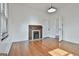 Bright living room features hardwood floors, modern lighting and decorative fireplace at 1449 Wadley Ave, East Point, GA 30344