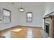 Bright living room with decorative fireplace, hardwood floors and modern lighting at 1449 Wadley Ave, East Point, GA 30344
