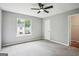 Bright bedroom featuring ceiling fan and a large window at 2049 Charter Ln, Lithonia, GA 30058