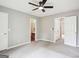 Spacious bedroom features neutral decor, a ceiling fan, and multiple entryways for convenience at 2049 Charter Ln, Lithonia, GA 30058