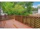 View of the deck with a wooden railing overlooking the lush backyard landscaping at 2049 Charter Ln, Lithonia, GA 30058