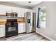 Bright kitchen featuring stainless steel appliances and wood countertops at 2049 Charter Ln, Lithonia, GA 30058