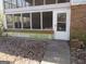 Back porch area with brick accents, screened-in area, and overgrown foliage at 526 Mount Carmel Church Rd, Temple, GA 30179