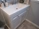 Close-up of a white bathroom sink with gray tile backsplash and simple, shaker-style cabinetry below at 526 Mount Carmel Church Rd, Temple, GA 30179