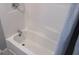 Clean and well-maintained white tub and shower with neutral colored wall at 526 Mount Carmel Church Rd, Temple, GA 30179
