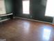 Neutral bedroom features natural light, wood floors, and plenty of space for furniture arrangement at 526 Mount Carmel Church Rd, Temple, GA 30179