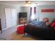 Bedroom with red and black decor, ceiling fan, and TV at 526 Mount Carmel Church Rd, Temple, GA 30179